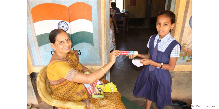 Head teacher Ms. Annama distributing free Colgate toothbrushes - IDA contribution Head teacher Ms. Annama distributing free Colgate toothbrushes - IDA contribution