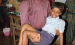 Teacher Mr. Mahesh with a student after tooth extraction